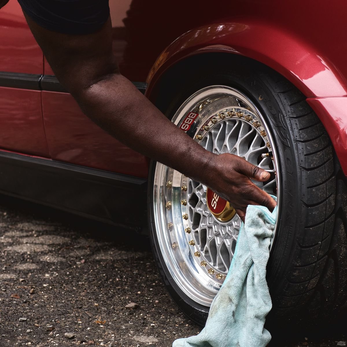 Cleaning a car alloy wheel with a cloth